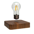Creative minimal self-rotating maglev bulb with ABS base and warm yellow light on a desk