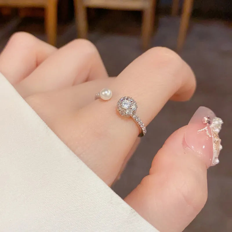 Gold and silver open-end women's ring with round zircon stones and pearl design on geometric band