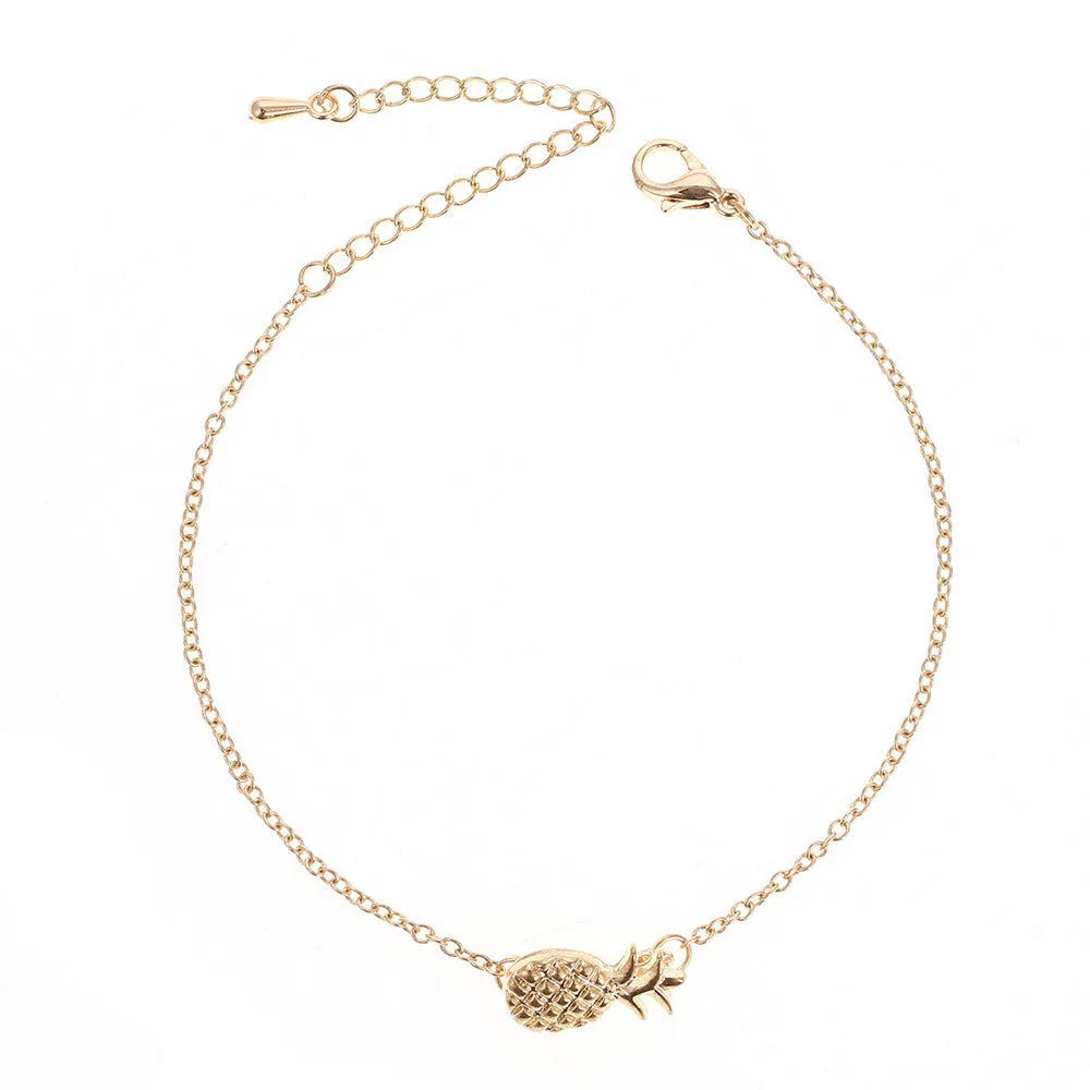 Women's alloy bracelet featuring a central pineapple charm in gold or silver colour.