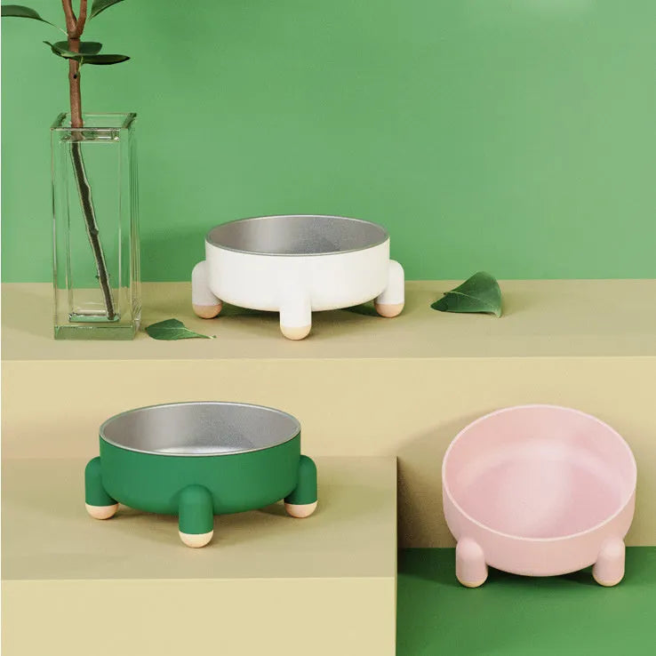 Green stainless steel pet bowl with a high foot and non-slip silicone base on a floor