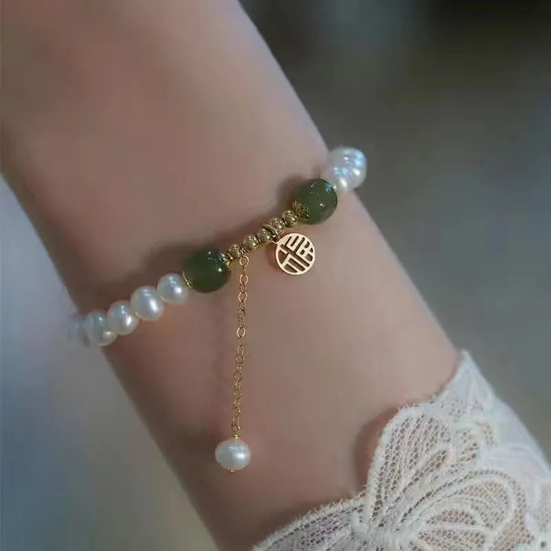 Chinese style glass bracelet with bamboo joint details in a red Lvzhu Duobao design.