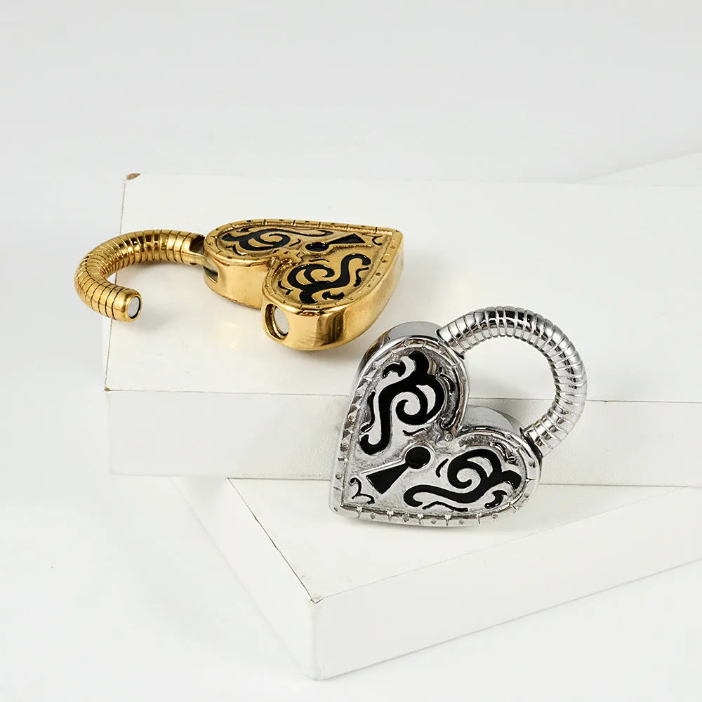 A pair of women's heart-shaped earrings in stainless steel with a gold electroplated finish.