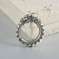 A pair of large antique silver alloy earrings featuring a hollow out geometric dragon design.