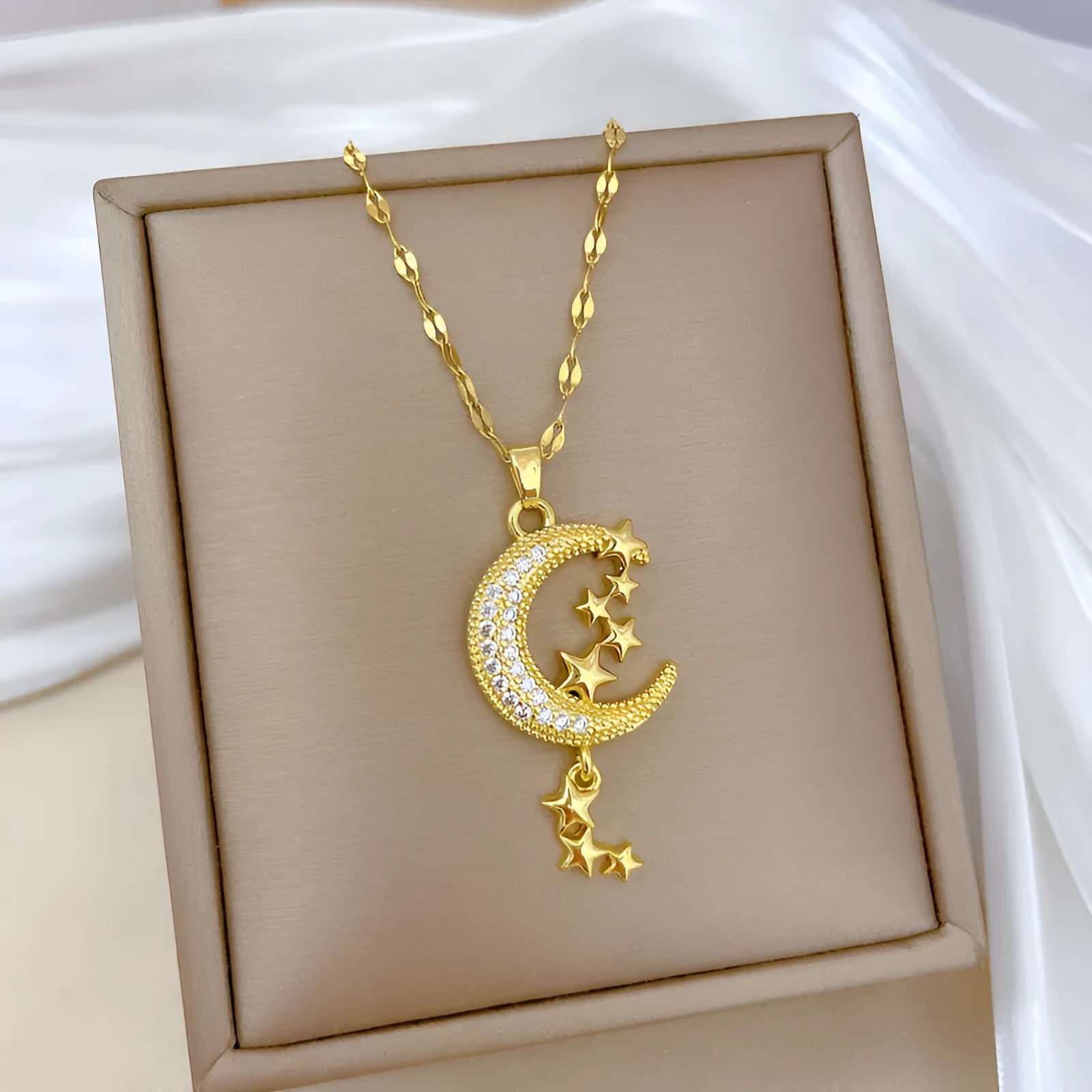 Stainless steel and copper moon pendant necklace with geometric diamond pattern and tassel design