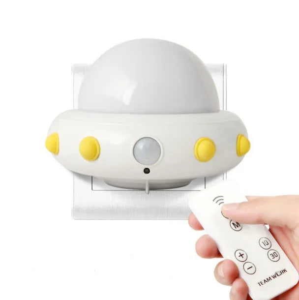 Remote control UFO shaped bedside night light in blue, pink, or white with cartoon design