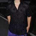 Man's loose fit short sleeve shirt with a heavy industry floral print in black.