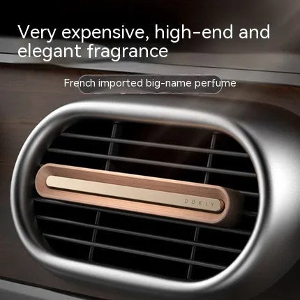 Solid long strip car aromatherapy ornament clipped to a car air vent, in walnut wood finish.