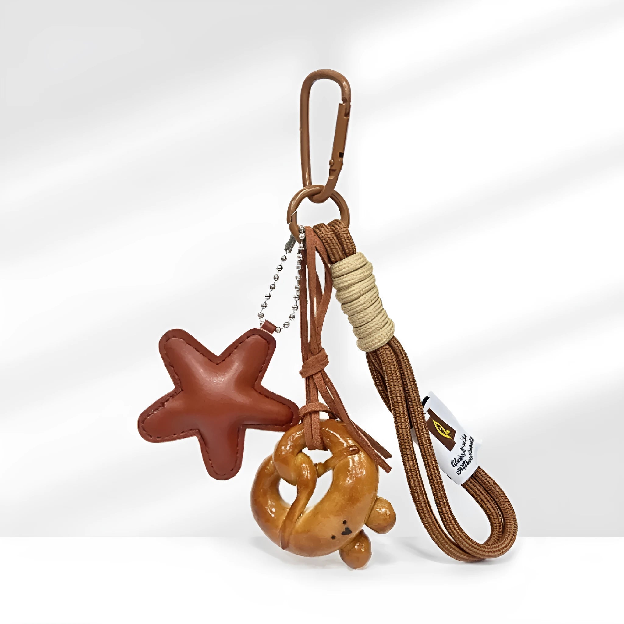 Handmade resin handbag pendant with soda bread designs including cartoon croissant and brown stars