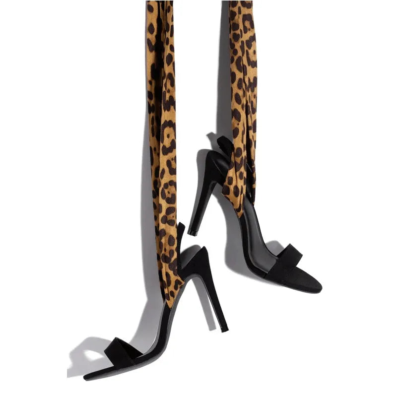 Light brown women's high heels with leopard print and Roman cross straps on a super high heel.