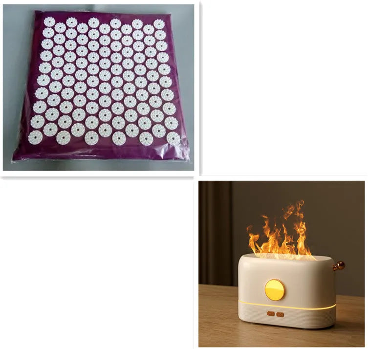 Black USB desktop humidifier with decorative orange flame effect and water tank on a wooden desk.