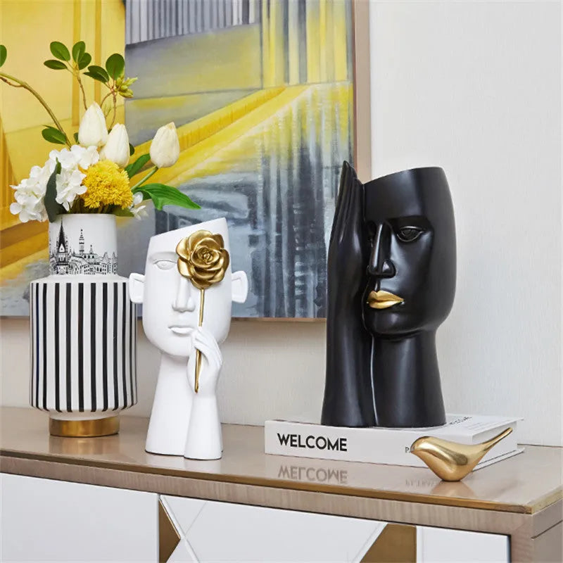 Modern black and white resin vase with sculpted body shape on living room table