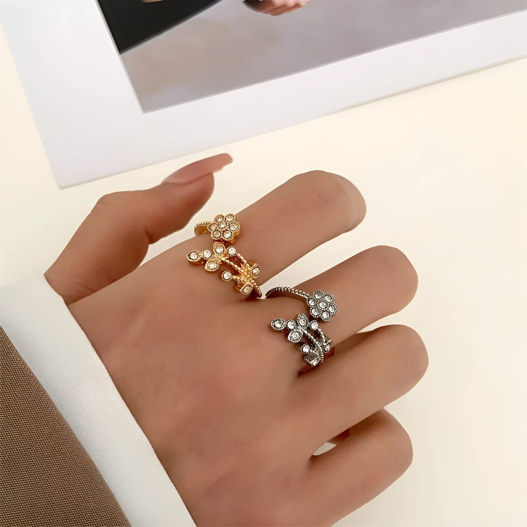 Women's open ring with floral leaf design in gold tone on white background