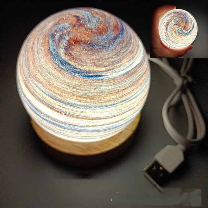 Planet night light with USB cable and base in modern simple design showing spherical shape