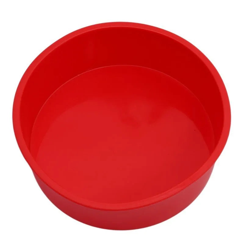 Red round silicone cake mould on a baking tray showing 8 inch size with smooth interior