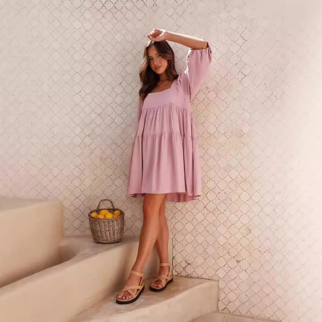 A child's orange puff sleeve dress with a square collar and backless design, featuring an A-line silhouette.