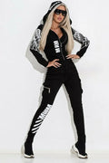 Black women's casual hooded suit with wings graphic print, featuring a zip-front top and matching trousers.