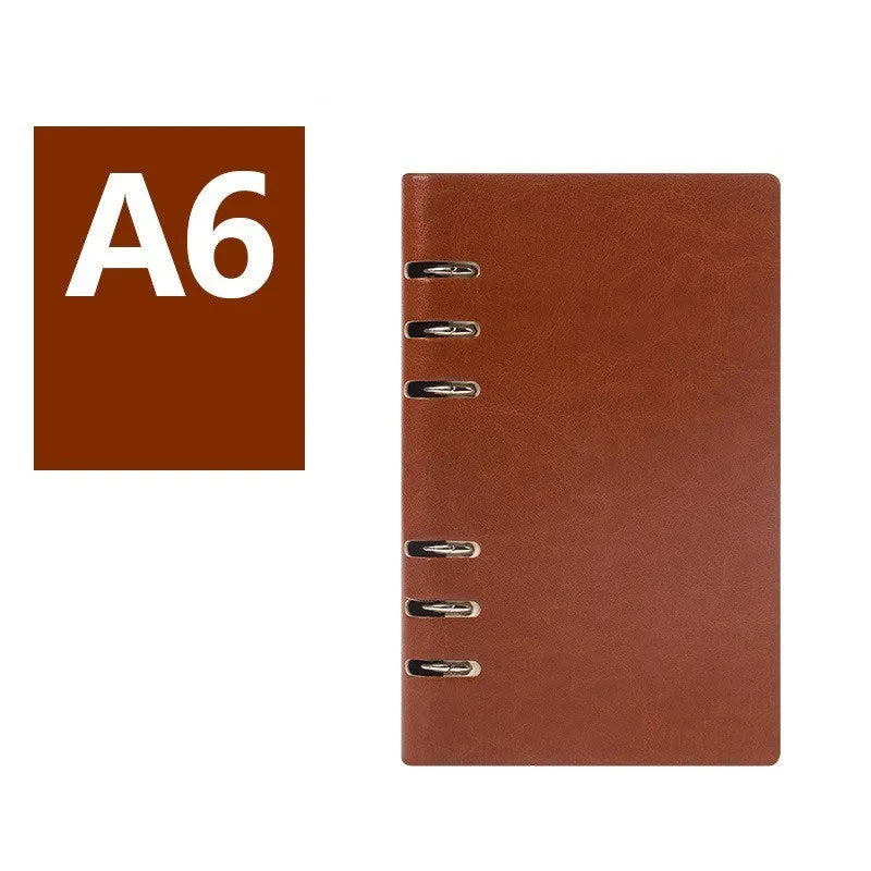 Simple business notebook with imitation leather cover showing loose-leaf binding and beige road forest paper