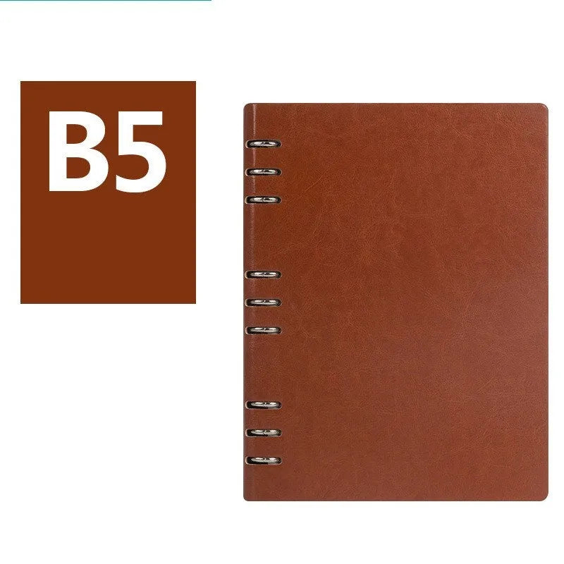 Simple business notebook with imitation leather cover showing loose-leaf binding and beige road forest paper