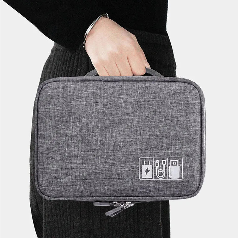 Grey waterproof electronics organiser with double-layer interior, adjustable dividers, and carrying handle