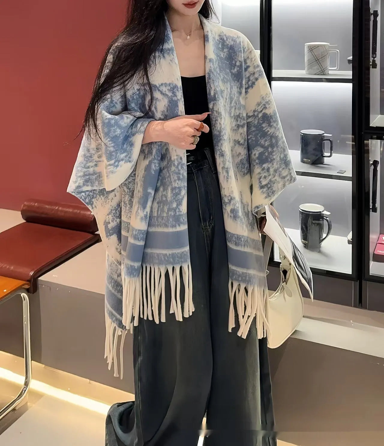 Women's casual polyester scarf cape with tassels worn as a shawl.