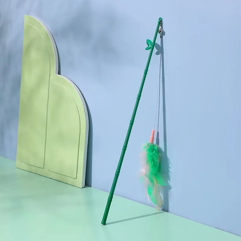 Green cat feather wand toy with bell and feather attachments for interactive play