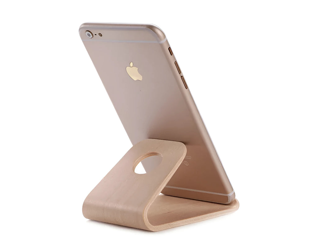 Solid wood iPhone stand in walnut finish on a desk