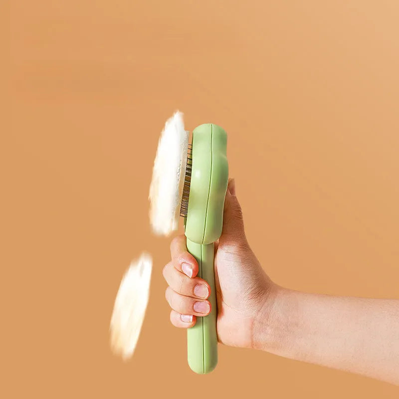 Large green self-cleaning cat comb magic wand with stainless steel needle teeth for pet grooming.