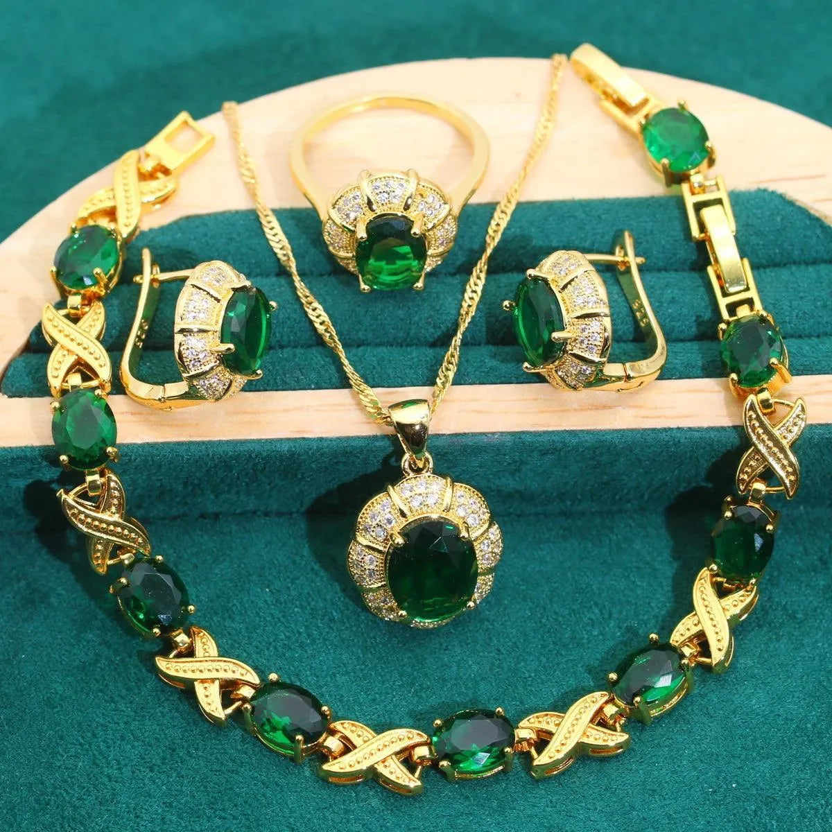 Gold plated jewellery set with blue cubic zirconia stones, showing necklace, earrings, ring, and bracelet.