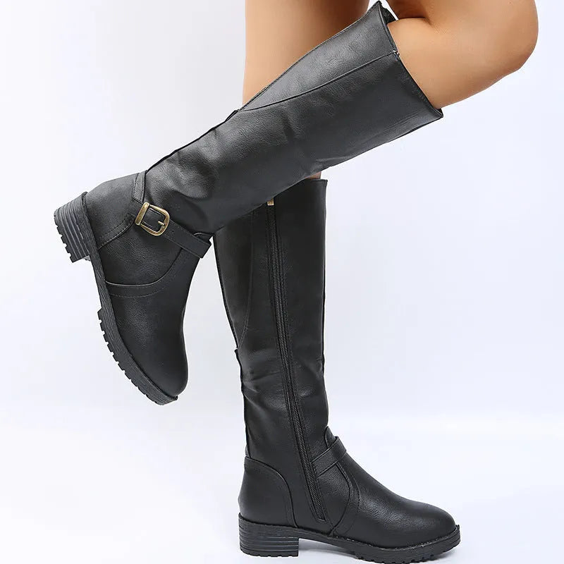Women's yellow knight high boots with buckle details on shaft and a square heel.