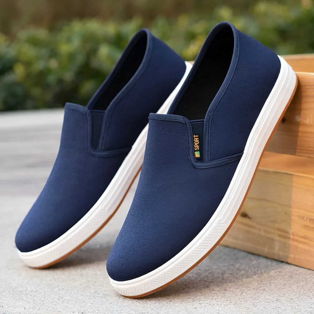 Men's black and blue canvas slip-on shoes with low-top design and round toe