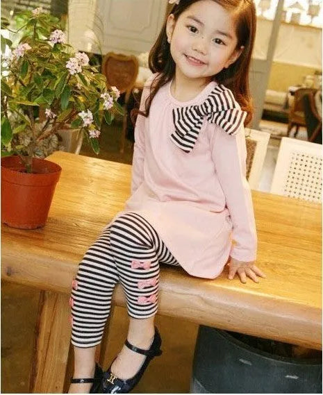 Pink cotton girls two-piece outfit with short-sleeve T-shirt and matching shorts on hanger.