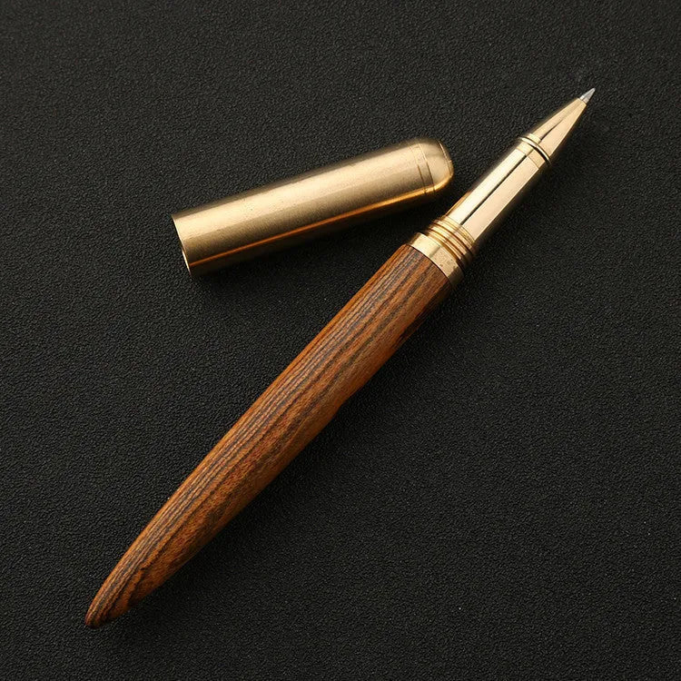 Brass and sandalwood solid wood signature pen with wooden barrel and brass fittings on a desk