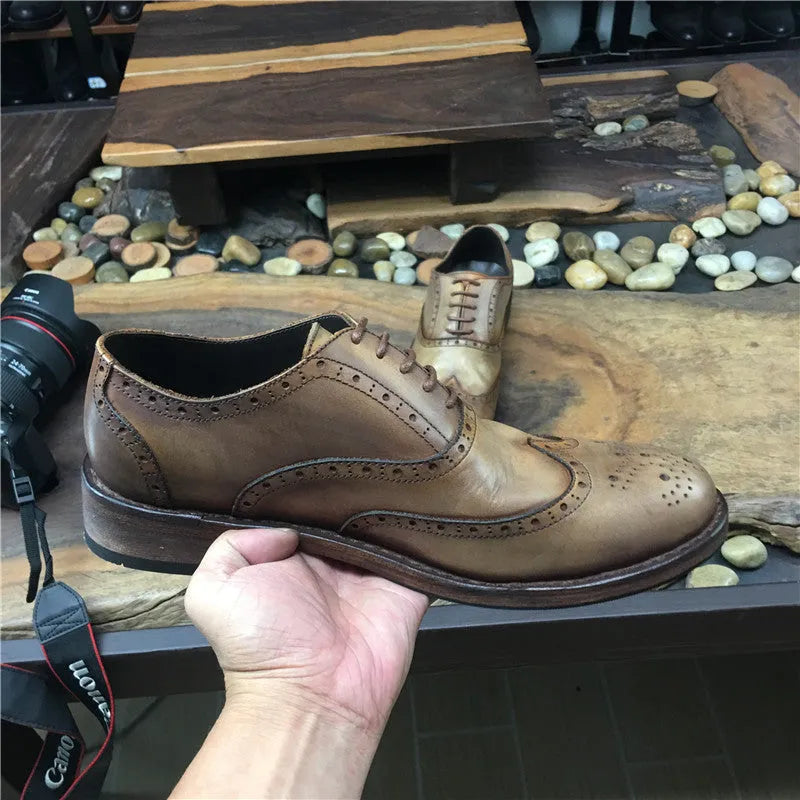 Light brown vintage engraved men's lace-up leather shoes with distressed finish and round toe.