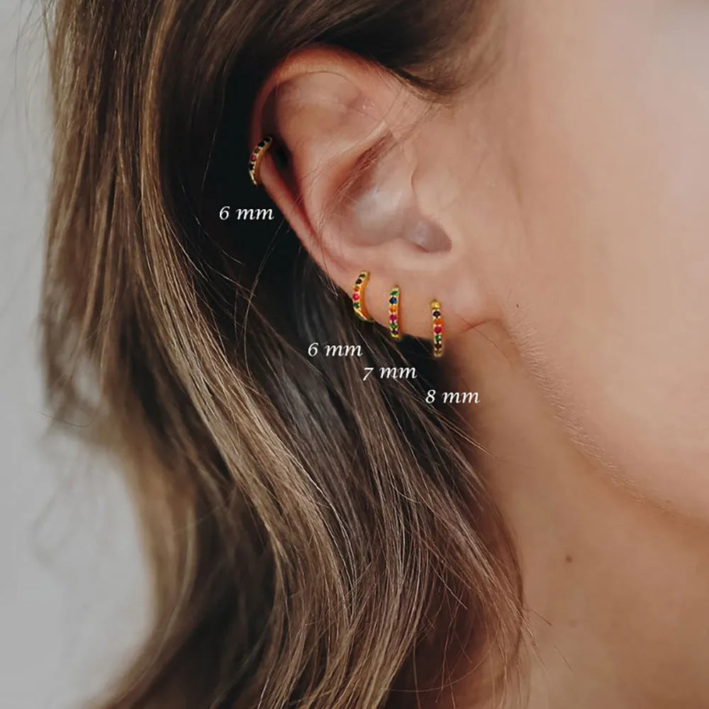 Geometric circle zircon perforated stud earrings in gold, rose gold, and silver colours showing perforated pattern detail