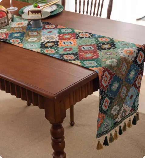 Country European retro style table flag with long handwoven tassels draped over a wooden sideboard.
