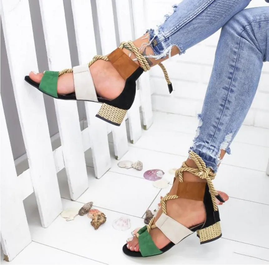 Women's beige suede sandals with thick heel, front strap, and ankle strap on a white background.