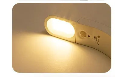 USB human body induction night light with light control, black colour, warm style LED lamp on bedside table