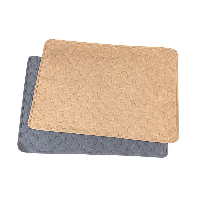 Pack of grey and tan washable, reusable dog pee pads in various sizes on a wooden floor.