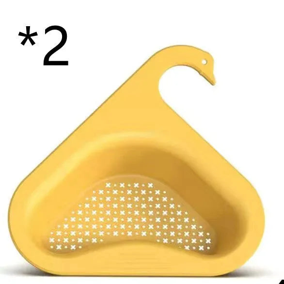 Yellow hanging swan drain basket made of plastic, fitted on a kitchen sink edge with space for vegetables and utensils