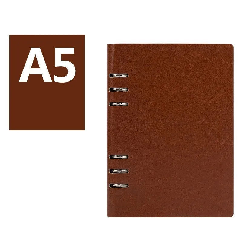 Simple business notebook with imitation leather cover showing loose-leaf binding and beige road forest paper