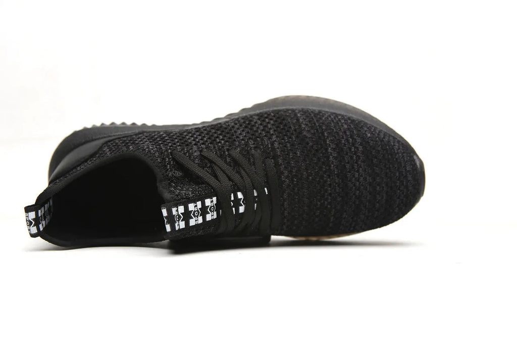 Black steel toe cap safety shoes with anti-static properties and EVA construction on a work floor.