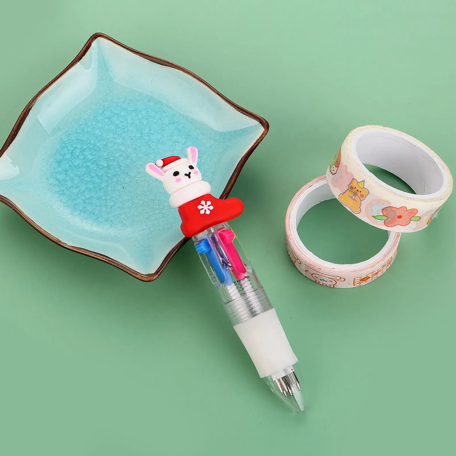 Compact 11cm Christmas-themed press-action ballpoint pen with festive designs.
