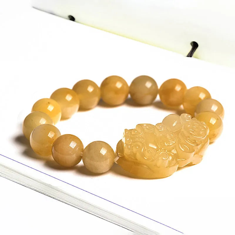 Carved Jinsi Jade money bracelet with Chinese characters on leather cord in gold thread colour