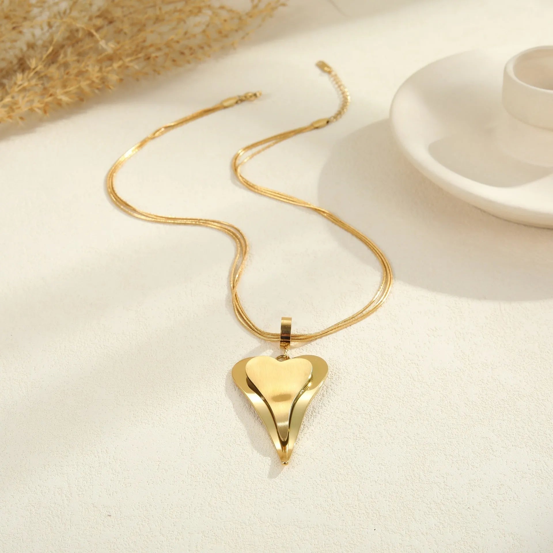 Stainless steel double heart snake bones chain necklace with geometric pendant in gold or steel electroplated finish