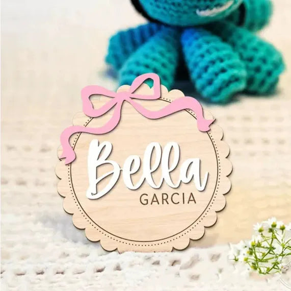 A square wooden ornament personalised with a baby's name for nursery decoration or photo prop.
