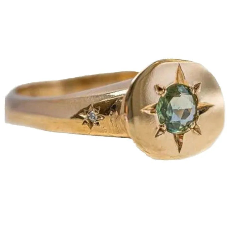 Golden adjustable ring with oval zircon centrepiece and star pattern detail