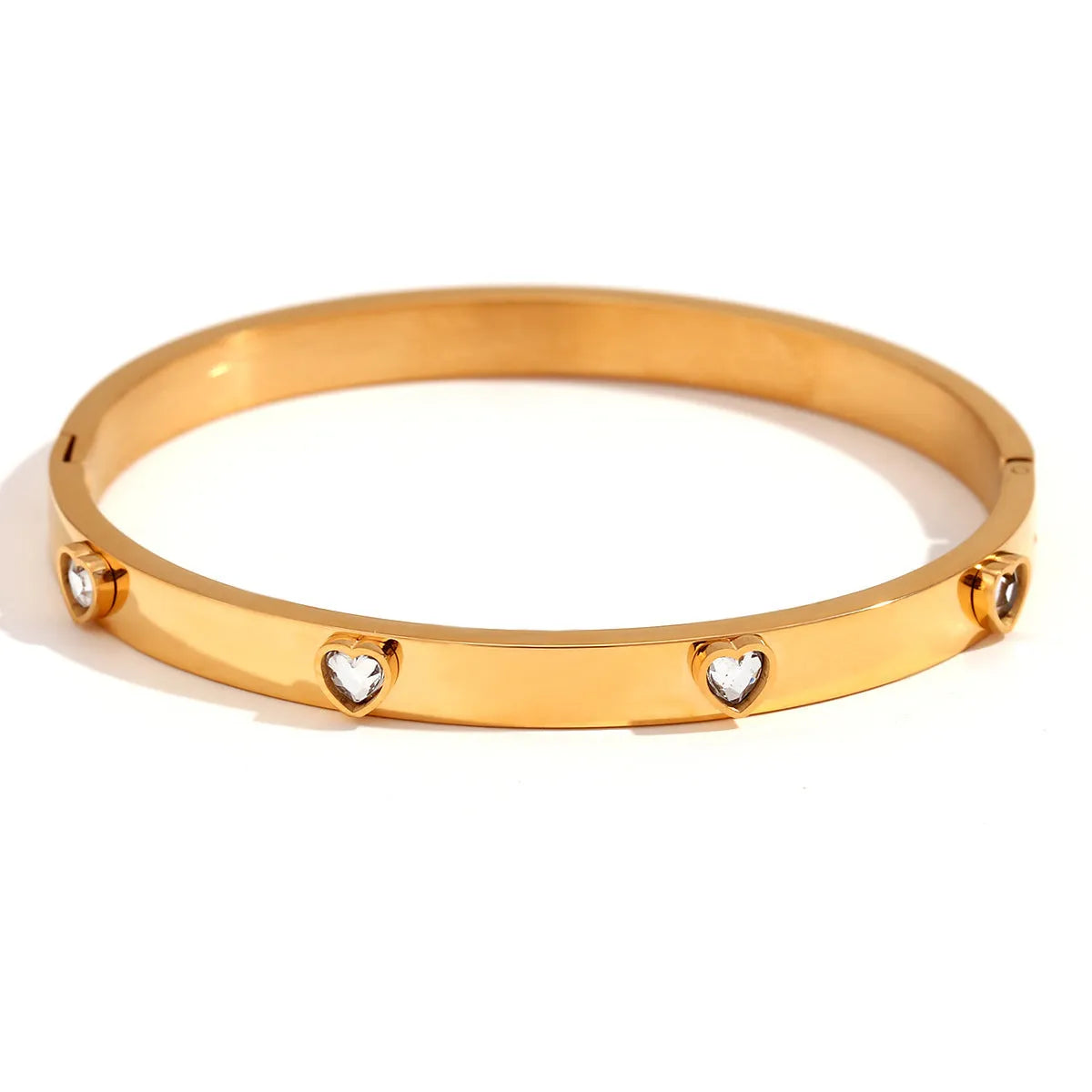 Stainless steel bracelet with micro-inlaid peach heart charm in golden electroplated finish