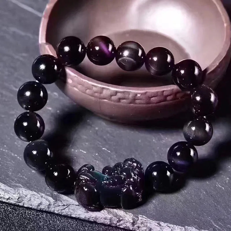 Natural obsidian eye crystal bracelet showing characteristic patterning on beads