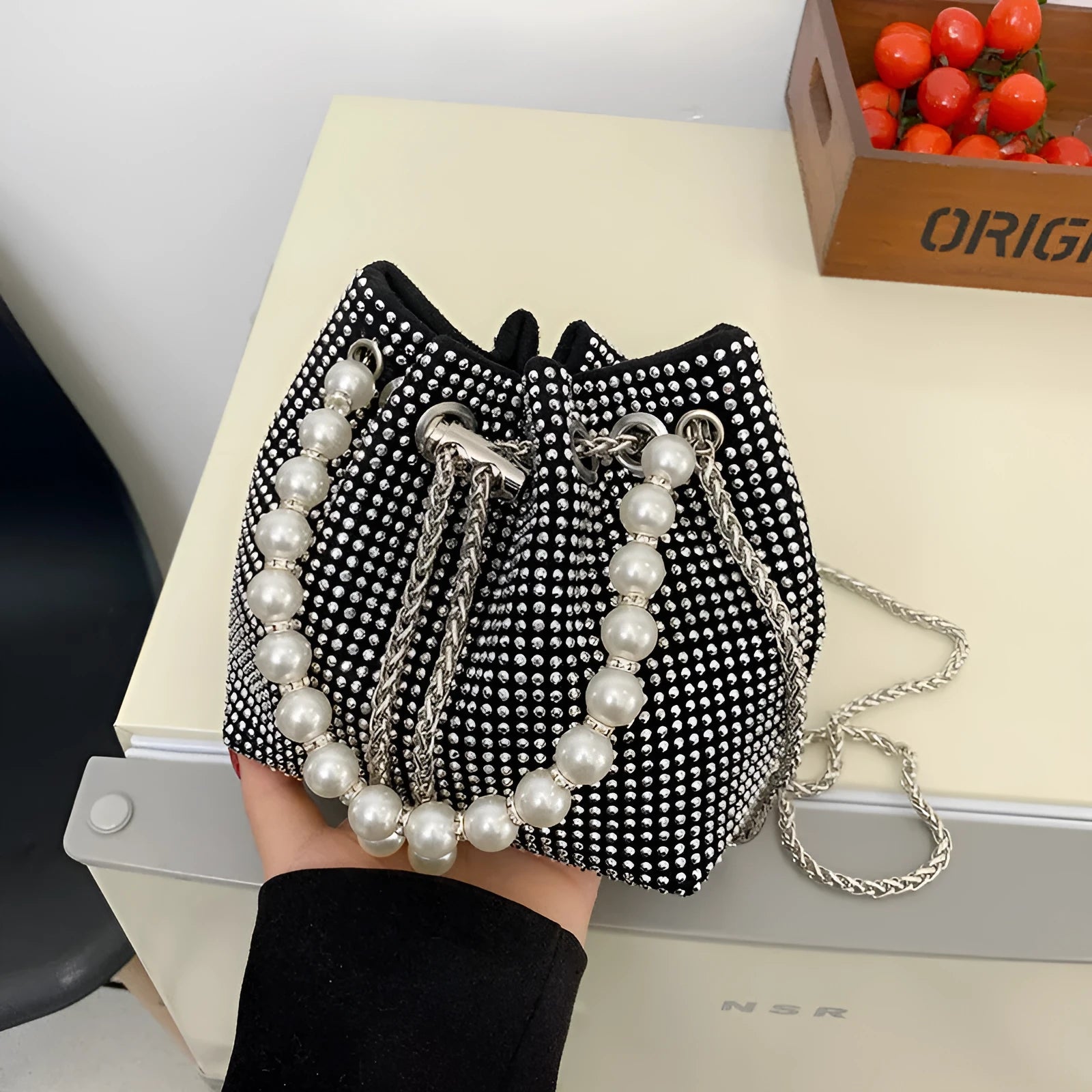 Light diamond pattern shoulder bag with western style chain crossbody and bucket shape design
