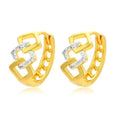 A pair of gold geometric earrings with a hollow out design and clip-on fastening.